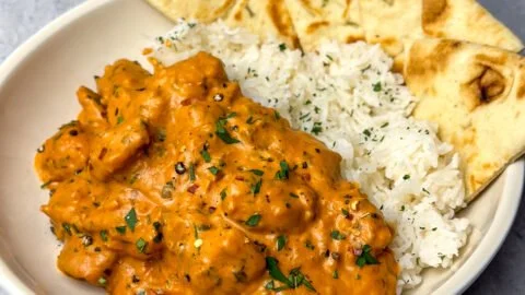 Delicious homemade butter chicken served with rice and naan